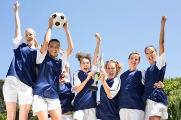 Girls cheering with soccer ball